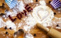 Heart of flour, rolling pin, berries and utensils for baking on wooden background.Happy Valentine`s Day. Love and home