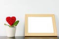 Heart flower in wihite pot with photo frame Royalty Free Stock Photo