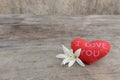 Red hearts ` I love You` with Millingonia on the wooden rough table.