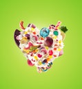 Heart form from whipped cream with sweets, jellies, heart front view. Crazy freakshake food trend. Front view of whipped