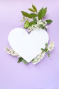 Heart frame with flowering bird cherry on violet background Royalty Free Stock Photo