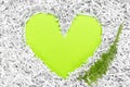 Heart frame made of shredded paper and a green leaf Royalty Free Stock Photo