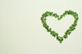 Heart of green clover leaves on light background, flat lay. Space for text Royalty Free Stock Photo