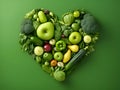 Heart of green fruits and vegetables isolated on deep green background. Green life concept and healthy eating lifestyle. Shape of Royalty Free Stock Photo