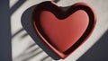 heart on a grey background A red stone heart with a shadow on it. The heart is solid and strong, and the shadow is a sign of love