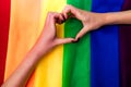 heart hand of female on the multi color flag rainbow background Royalty Free Stock Photo