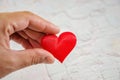 Heart on hand for philanthropy concept / woman holding red heart in hands for valentines day or donate help give love warmth take Royalty Free Stock Photo