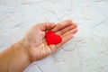 Heart on hand for philanthropy concept / woman holding red heart in hands for valentines day or donate help give love warmth take Royalty Free Stock Photo