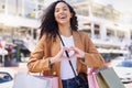 Heart, hands, shopping and woman with smile for retail, fashion and designer sale in the city of Miami. Portrait of a