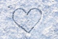 Heart handwritten on snow. Love symbol in winter