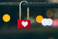 Heart hanging on clothesline at night. Red padlock on a rope, bokeh of evening city lights. Symbol of love. Romantic concept. Royalty Free Stock Photo