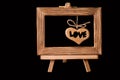 Heart hanging in old picture frame on black background Royalty Free Stock Photo