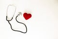 Heart health and prevention concept. Stethoscope and red heart of crochet on white isolated background with space for text