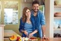 Heart-healthy cooking for two. Portrait of a happy young couple preparing a healthy meal together at home. Royalty Free Stock Photo