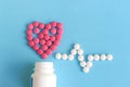 Heart and heart rhythms from pink and white pills Royalty Free Stock Photo