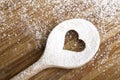 Heart hole spoon on the wooden pastry board