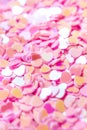 Heart holographic pink confetti background. 14 february macro glitter pattern. Holiday love wallpaper. Selective focus Royalty Free Stock Photo