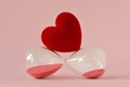Heart on hourglass lying on pink background - Concept of time and love Royalty Free Stock Photo