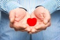 A Heart in human hands on white brick background Royalty Free Stock Photo