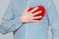 A Heart in human hands on white brick background Royalty Free Stock Photo