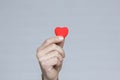 A Heart in human hands on white brick background Royalty Free Stock Photo