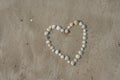 Heart image on sand of beach.