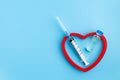 Heart Injection And Vaccine Vial. Covid-19 Cure. Medical Ampoule Dose And Needle On Blue Background, Royalty Free Stock Photo