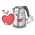 With heart kitchen electric kettle on a mascot Royalty Free Stock Photo