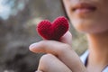 Heart knit in the hands of the girl. Royalty Free Stock Photo