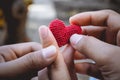 Heart knit in the hands of the girl. Royalty Free Stock Photo