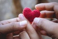 Heart knit in the hands of the girl. Royalty Free Stock Photo