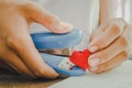 Heart knit in the hands of the girl with stapler. Royalty Free Stock Photo