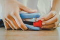 Heart knit in the hands of the girl with stapler. Royalty Free Stock Photo