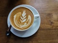 Heart leaf shape milk foam on top of latte art drawing coffee