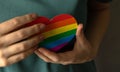 Heart in LGBT rainbow colors in a hands. Pride month and tolerance background photo