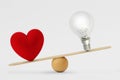 Heart and light bulb on scale - Concept of love priority over brain in life Royalty Free Stock Photo