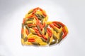 Heart lined with colored pasta on a white background Royalty Free Stock Photo