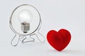 Heart looking in the mirror and seeing itself as a light bulb - Concept of dualism heart/mind, emotion/reason