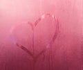 Heart, love symbol on sweaty glass, pink gradient background