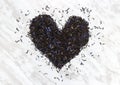 Heart made of Black Earl gray tea leaves Royalty Free Stock Photo