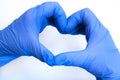 Heart made of blue gloves on a white background. gloved hands Royalty Free Stock Photo