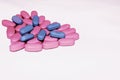 Heart made of blue and pink pills. Heart made of different colored tablets isolated on white. Copyspace for text. Epidemic, painki
