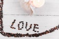 Heart made of coffee beans, white bag with gift and candle Royalty Free Stock Photo