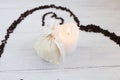 Heart made of coffee beans, white bag with gift and candle Royalty Free Stock Photo