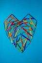 a heart made of colorful wooden sticks creatively arranged
