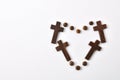 Heart made with crosses and beads on table white background Royalty Free Stock Photo