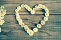 Heart made of daisies flowers in wooden background Royalty Free Stock Photo