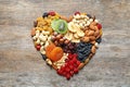 Heart made of different dried fruits and nuts on wooden background Royalty Free Stock Photo