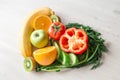 Heart made from different fruits and vegetables on light wooden table Royalty Free Stock Photo