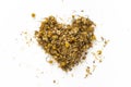 Heart made of dried chamomile tea, on white background Royalty Free Stock Photo